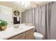 Neutral bathroom featuring a mirror, overhead lighting, and a shower with a gray curtain at 2247 E Ross Ave, Phoenix, AZ 85024