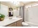 Neutral bathroom featuring a mirror, overhead lighting, and a shower with white tiling at 2247 E Ross Ave, Phoenix, AZ 85024