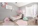 Bright bedroom features light gray walls, natural light, and colorful decor at 2247 E Ross Ave, Phoenix, AZ 85024