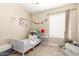 bedroom with neutral walls, cozy furnishings, and play-themed decor at 2247 E Ross Ave, Phoenix, AZ 85024