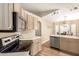 Open kitchen with stainless steel appliances, eat-in dining and natural wood floors at 2247 E Ross Ave, Phoenix, AZ 85024