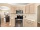 Updated kitchen with stainless steel oven and microwave and light wood cabinets at 2247 E Ross Ave, Phoenix, AZ 85024