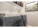 Modern laundry room with gray front-load washer and dryer and a shelf for storage at 2247 E Ross Ave, Phoenix, AZ 85024