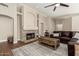 Spacious living room with a stone fireplace, ceiling fan, and comfortable seating at 2247 E Ross Ave, Phoenix, AZ 85024