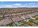 Aerial view showcases the backyard featuring a pool, artificial grass area, playground, and outdoor lounge at 22991 E Via De Olivos --, Queen Creek, AZ 85142