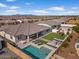 An aerial view highlights the backyard pool, artificial grass, playground, and outdoor seating area at 22991 E Via De Olivos --, Queen Creek, AZ 85142
