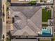 High-angle aerial shot of the roof, backyard pool, grass area, patio, and playground at 22991 E Via De Olivos --, Queen Creek, AZ 85142