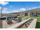 Backyard including artificial turf, outdoor seating, modern fire features, and swimming pool at 22991 E Via De Olivos --, Queen Creek, AZ 85142
