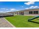 A spacious backyard featuring a large, well-maintained artificial grass area perfect for outdoor activities and relaxation at 22991 E Via De Olivos --, Queen Creek, AZ 85142