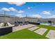 Beautifully landscaped backyard with artificial turf, seating areas, and modern fire pits at 22991 E Via De Olivos --, Queen Creek, AZ 85142