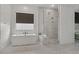 Stylish bathroom featuring a freestanding tub, glass enclosed shower, and marble patterned tile at 22991 E Via De Olivos --, Queen Creek, AZ 85142