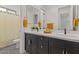 Modern bathroom features a double sink vanity, yellow accents, and patterned tile flooring at 22991 E Via De Olivos --, Queen Creek, AZ 85142