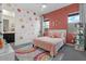 Bright bedroom featuring a colorful rug, flower decals and a cozy bed with charming decor at 22991 E Via De Olivos --, Queen Creek, AZ 85142