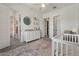 Bright Bedroom with crib, dresser, and a cozy rug, creating a comfortable space at 22991 E Via De Olivos --, Queen Creek, AZ 85142