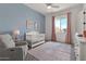 Cozy Bedroom with crib, glider, pink accents, and plenty of natural light at 22991 E Via De Olivos --, Queen Creek, AZ 85142