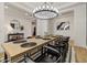 Open-concept dining area with stylish table, modern chandelier, and seamless flow to other living spaces at 22991 E Via De Olivos --, Queen Creek, AZ 85142