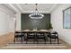 Elegant dining room boasts a large wooden table, modern lighting, and stylish decor at 22991 E Via De Olivos --, Queen Creek, AZ 85142