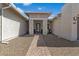 Inviting front entrance features a brick walkway, decorative stone, and a covered porch with brick pillars at 22991 E Via De Olivos --, Queen Creek, AZ 85142