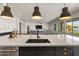 Bright, open kitchen featuring a large island with sink and barstool seating overlooks a living area at 22991 E Via De Olivos --, Queen Creek, AZ 85142