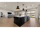 Spacious open floorplan kitchen with island, modern appliances, and seamless flow to the living space at 22991 E Via De Olivos --, Queen Creek, AZ 85142