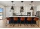 Kitchen island featuring modern pendant lighting and bar stool seating for a contemporary look at 22991 E Via De Olivos --, Queen Creek, AZ 85142