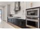 Modern kitchen features white cabinets, stainless appliances, and gas cooktop, creating a chef-friendly space at 22991 E Via De Olivos --, Queen Creek, AZ 85142