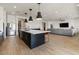 Spacious kitchen with a large center island that flows into the living room at 22991 E Via De Olivos --, Queen Creek, AZ 85142