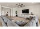 Cozy living room with a large sectional, modern TV console, and stylish decor accents at 22991 E Via De Olivos --, Queen Creek, AZ 85142