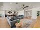 Bright, open-concept living room with wood floors, a plush gray couch and a stylish rug at 22991 E Via De Olivos --, Queen Creek, AZ 85142