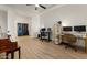 Bright office space with a ceiling fan, multiple workstations, and minimalist decor at 22991 E Via De Olivos --, Queen Creek, AZ 85142
