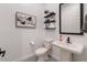 Chic powder room featuring patterned tile floor, pedestal sink, and modern decor at 22991 E Via De Olivos --, Queen Creek, AZ 85142