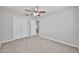 This bedroom features carpeted floors, a ceiling fan and a closet for ample storage space at 2617 N 40Th Ave, Phoenix, AZ 85009