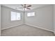 This bedroom features carpeted floors, a ceiling fan and two windows that let in natural light at 2617 N 40Th Ave, Phoenix, AZ 85009