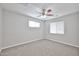 This bedroom features carpeted floors, a ceiling fan and two windows that let in natural light at 2617 N 40Th Ave, Phoenix, AZ 85009