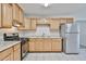 Bright kitchen with tile flooring, stainless steel appliances, and light wood cabinetry at 2617 N 40Th Ave, Phoenix, AZ 85009