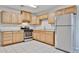 Well-lit kitchen features stainless steel appliances, tiled flooring, and light wood cabinets at 2617 N 40Th Ave, Phoenix, AZ 85009