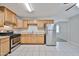 Bright kitchen with tile flooring, stainless steel appliances, and light wood cabinetry at 2617 N 40Th Ave, Phoenix, AZ 85009