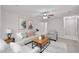 Inviting living room features a plush sofa, stylish decor, and a ceiling fan at 2617 N 40Th Ave, Phoenix, AZ 85009