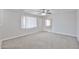 Neutral living room featuring carpet, a ceiling fan, and big windows at 2617 N 40Th Ave, Phoenix, AZ 85009
