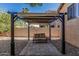 Backyard pergola on a paved platform with gravel landscaping behind a block fence at 26249 N 68Th Ln, Peoria, AZ 85383