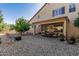 Large backyard with a covered patio, gravel landscape, and the rear exterior of the home at 26249 N 68Th Ln, Peoria, AZ 85383