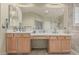 Bathroom featuring double sinks, vanity, and large mirror at 26249 N 68Th Ln, Peoria, AZ 85383