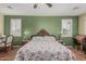 Spacious bedroom with wood floors, ceiling fan, and plantation shutters at 26249 N 68Th Ln, Peoria, AZ 85383