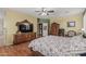Spacious bedroom with wood floors, ceiling fan, and plantation shutters at 26249 N 68Th Ln, Peoria, AZ 85383