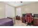 Bedroom setup as an office, featuring tile flooring, a ceiling fan, and shuttered window at 26249 N 68Th Ln, Peoria, AZ 85383