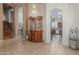 Elegant entryway with a crystal chandelier and view into the kitchen at 26249 N 68Th Ln, Peoria, AZ 85383