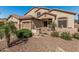 Well-maintained home featuring a three-car garage, desert landscaping and a tiled front entry at 26249 N 68Th Ln, Peoria, AZ 85383