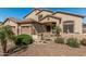 Well-maintained home featuring a three-car garage, desert landscaping and a tiled front entry at 26249 N 68Th Ln, Peoria, AZ 85383