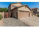 Side view of a 3-car garage with a private gated entrance on a paved driveway at 26249 N 68Th Ln, Peoria, AZ 85383