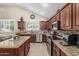 Charming kitchen featuring granite countertops, stainless steel appliances, and custom cabinetry at 26249 N 68Th Ln, Peoria, AZ 85383